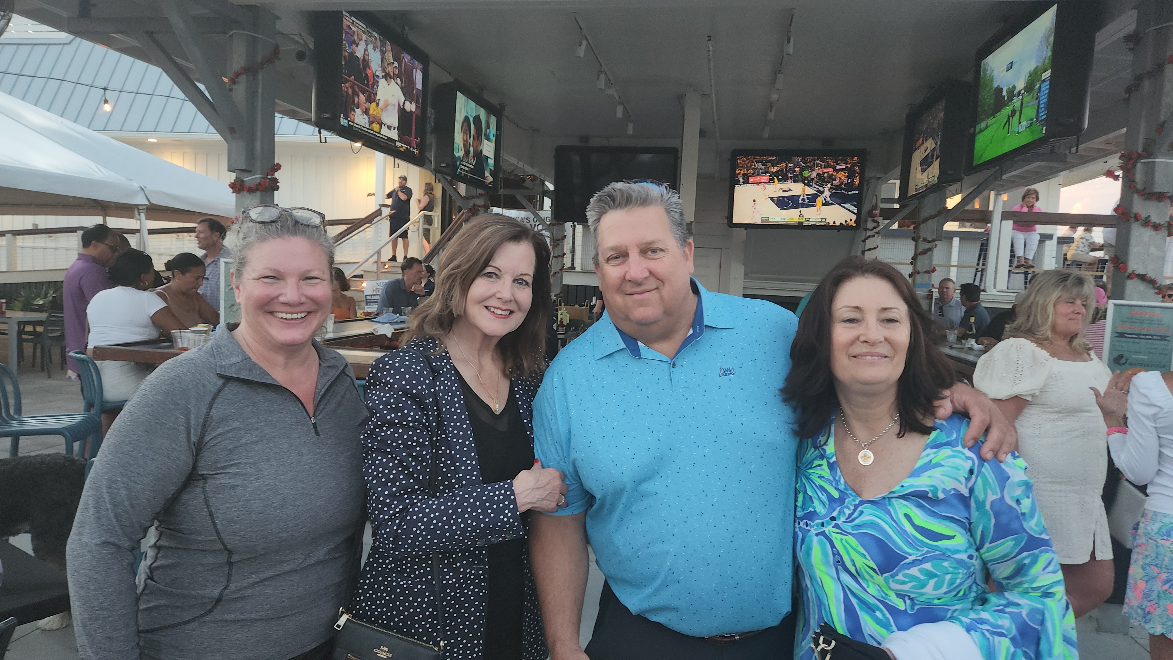 Wild Dunes members enjoying an evening out at a waterfront bar
